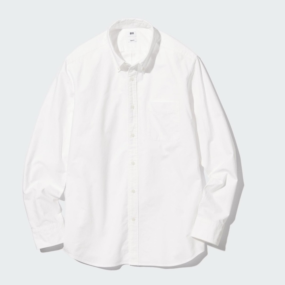 Three Uniqlo men’s white Oxford button down shirts.